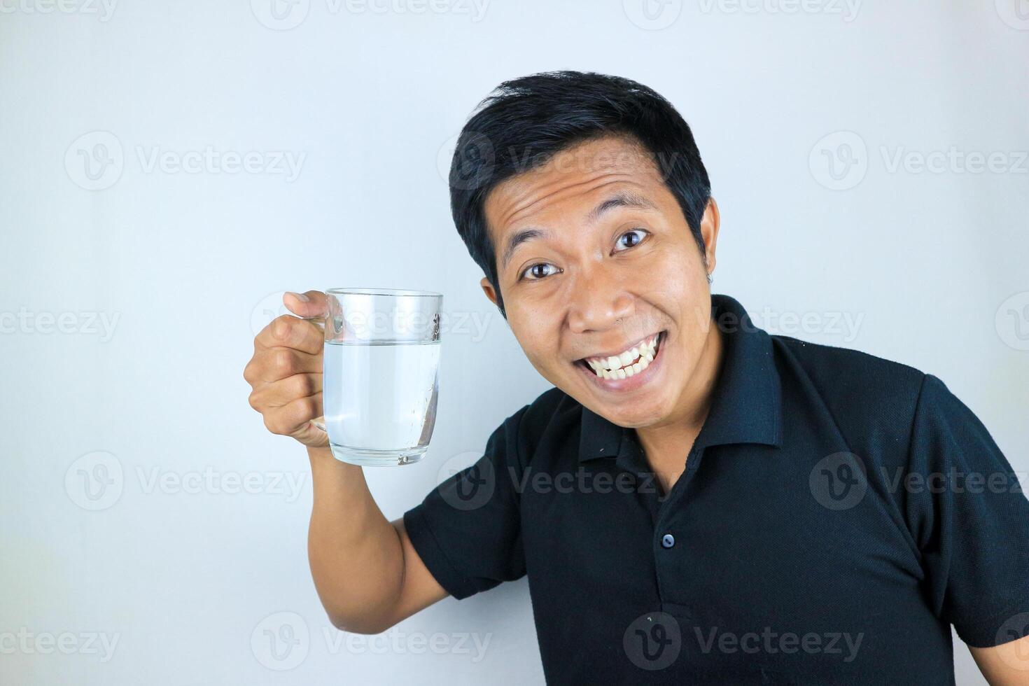 smiling face expression young asian man hold drinking glass. healthcare concept photo