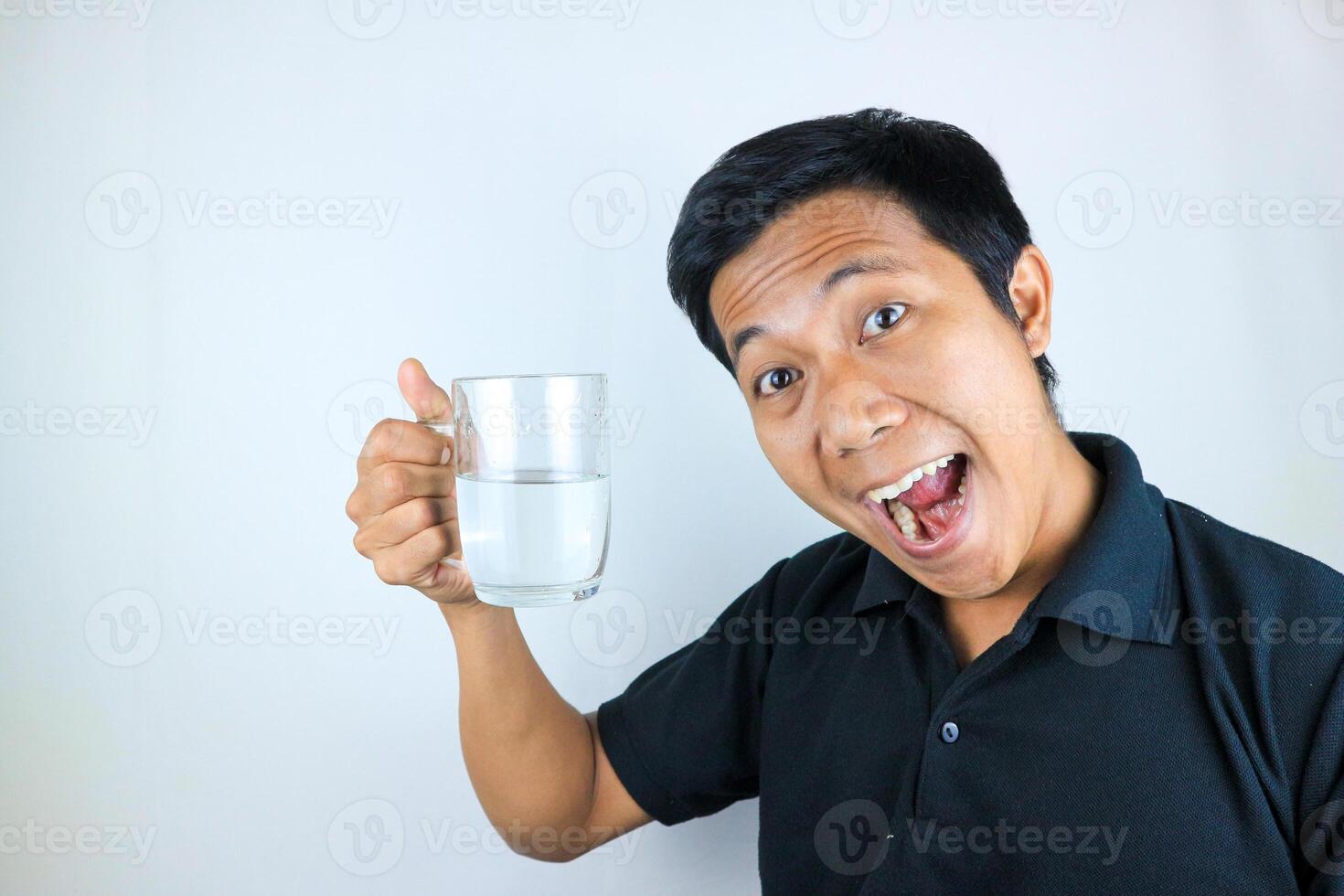 smiling face expression young asian man hold drinking glass. healthcare concept photo