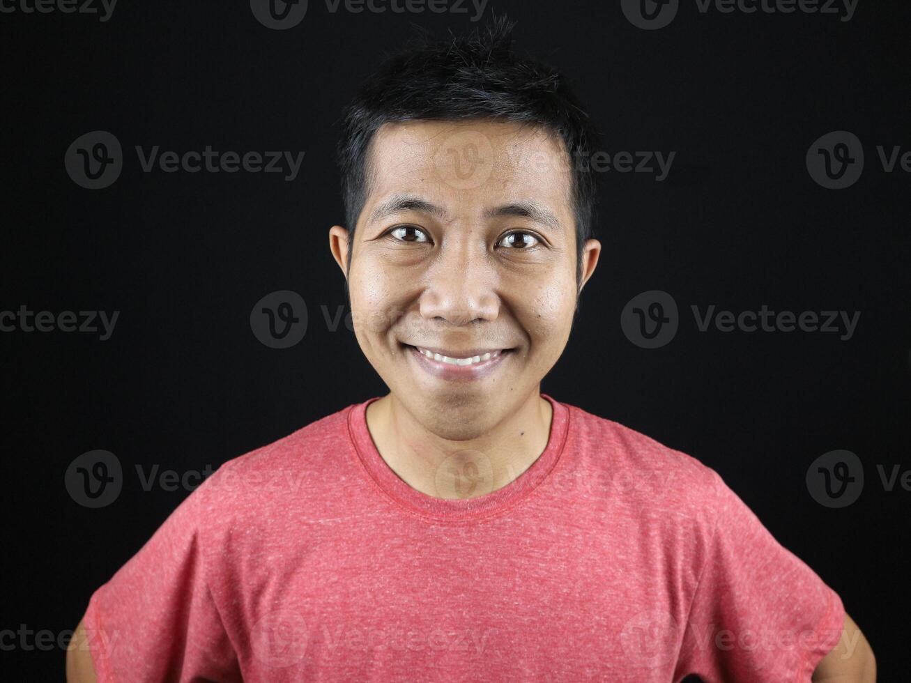 Asian man smiling looking at camera with happy face on black background for character photo