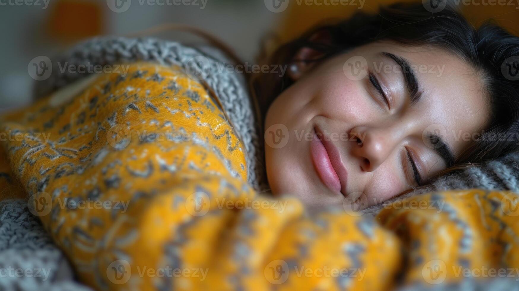 A woman is lying down in bed, her eyes closed in relaxation or sleep photo