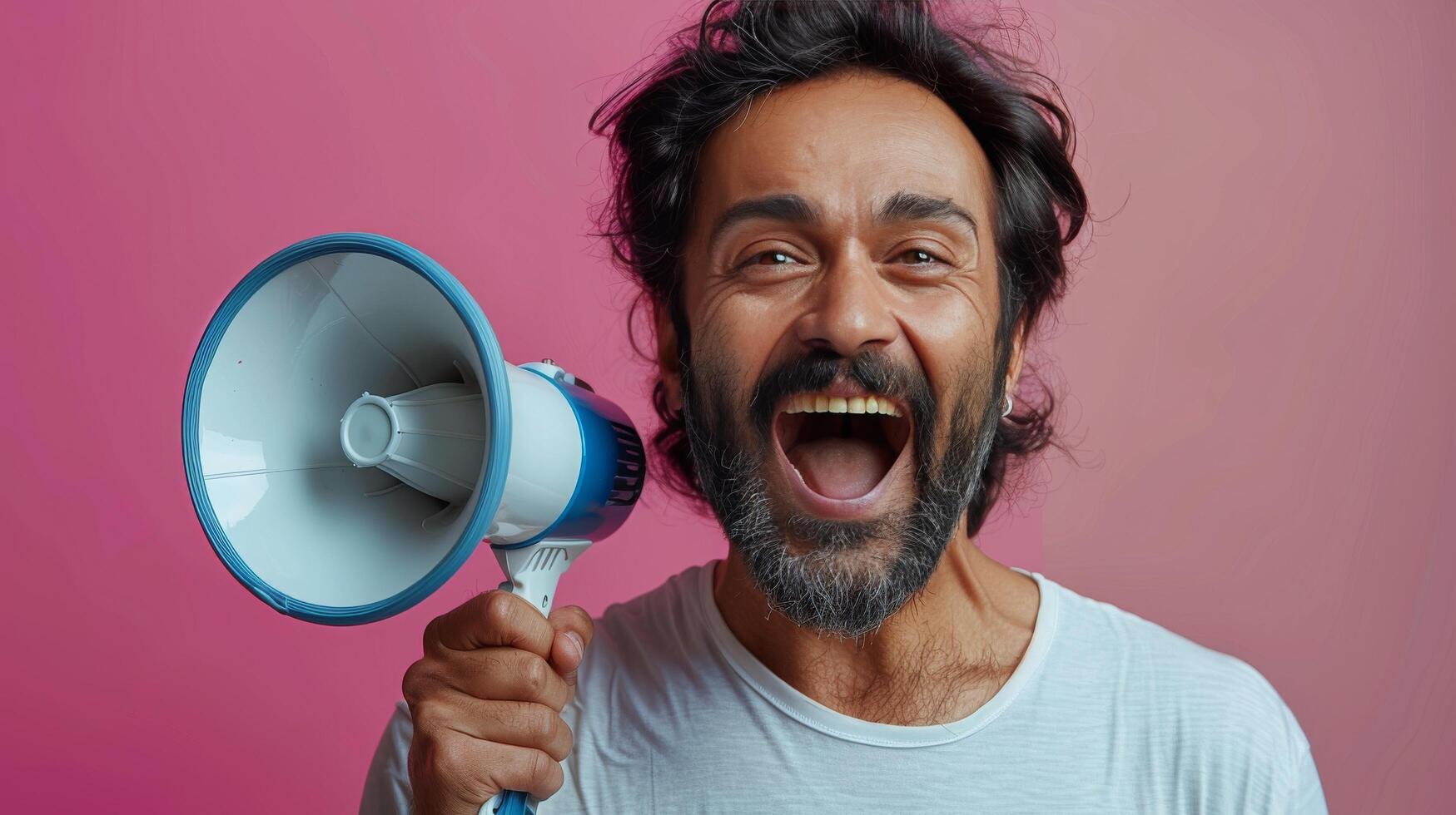 Man Holding Blue and Black Megaphone photo