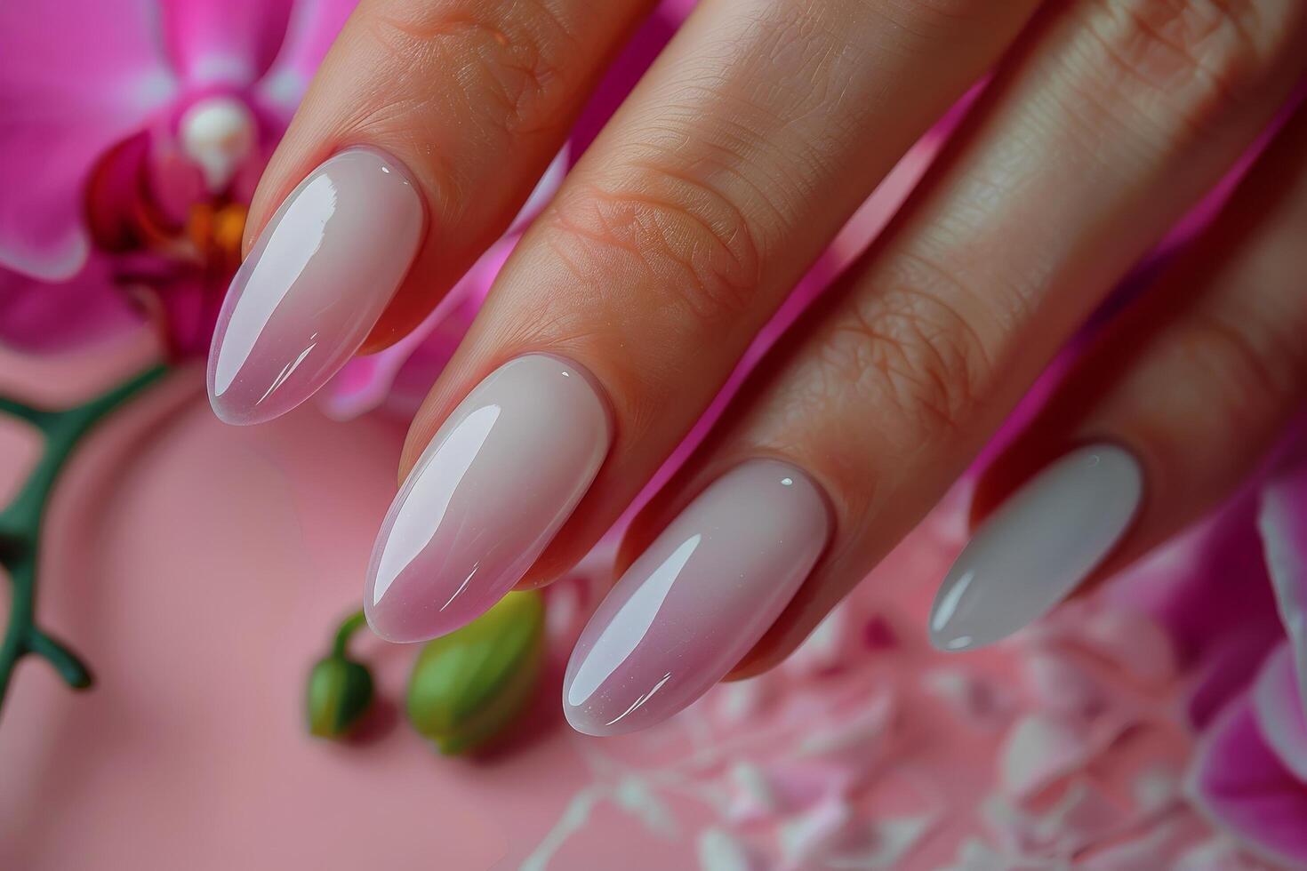 Womans Hand With White Manicure and Pink Flowers photo