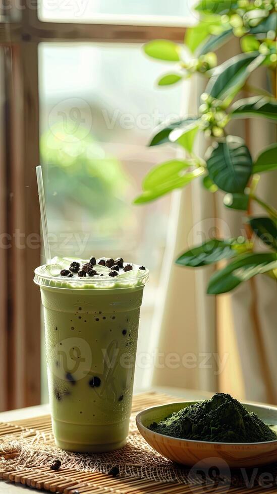 cup of green tea matcha milk ice drink is placed on the bamboo mat photo