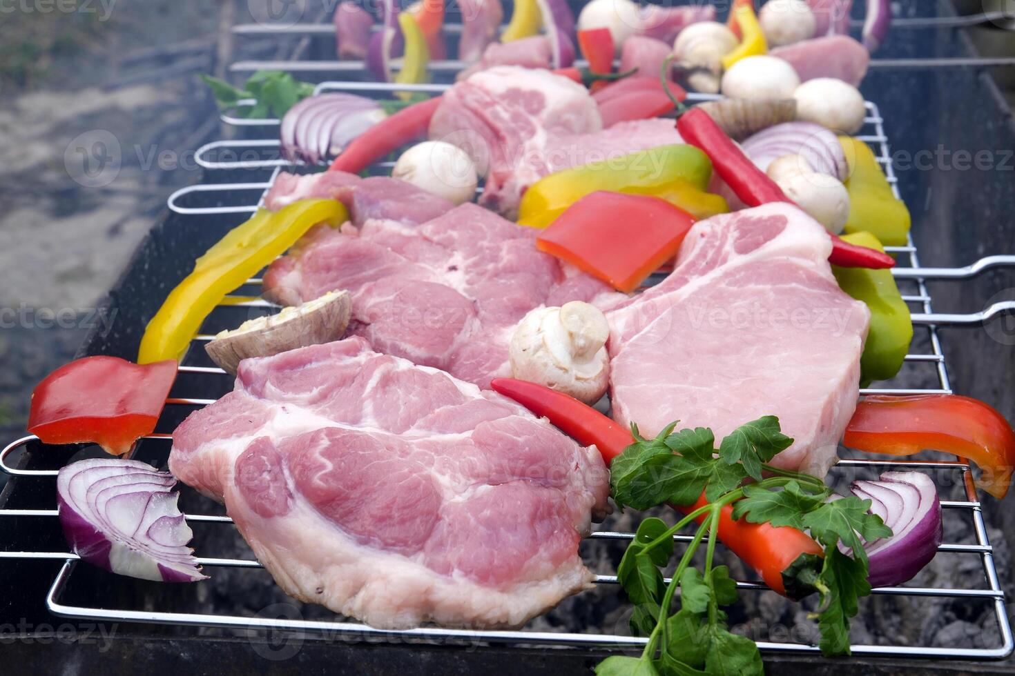 Pieces of lamb meat are on the counter in the market. fresh raw beef shish kebab with pepper chunk on black big grill bbq photo