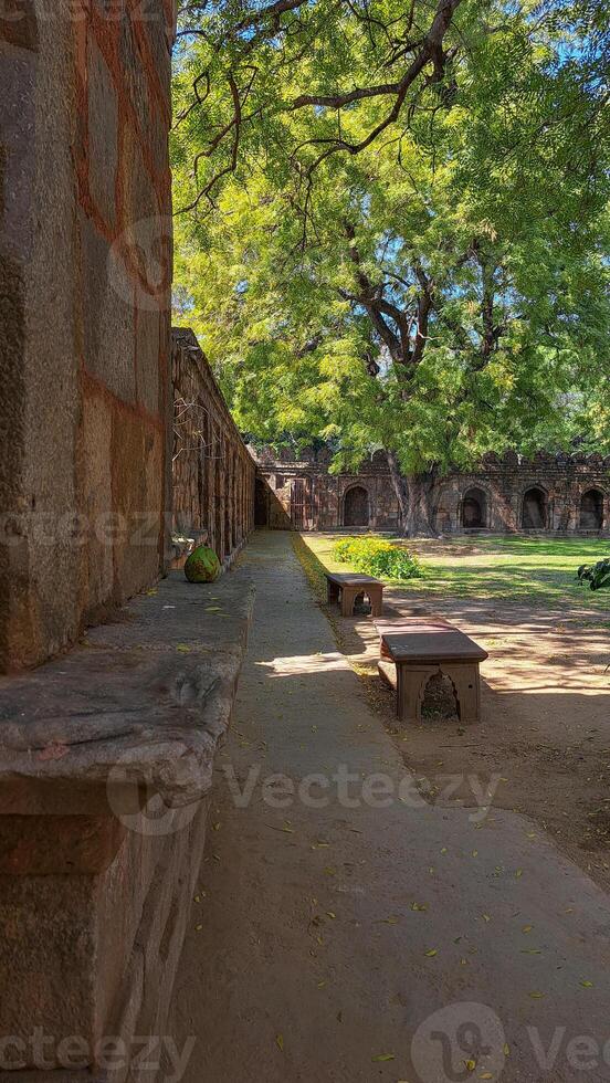 Sikandar Lodi Tomb, Delhi, arched corridors, domed chambers, carved sandstone walls, testament to ancient craftsmanship, Indo-Islamic architecture, preserved historical monument, heritage value photo