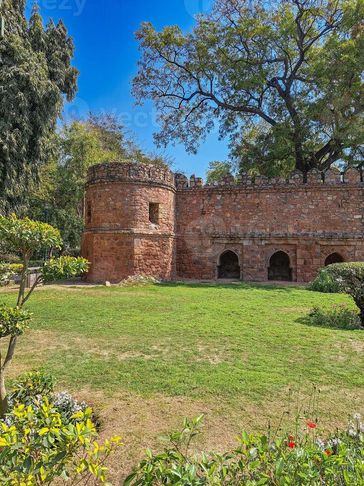 Ancient fortress wall near mausoleum, Sikandar Lodi Tomb, Delhi. Intact battlements, arched recesses, bastion. Indo-Islamic architecture. Historical monument, citadel, ramparts. Mughal Empire photo