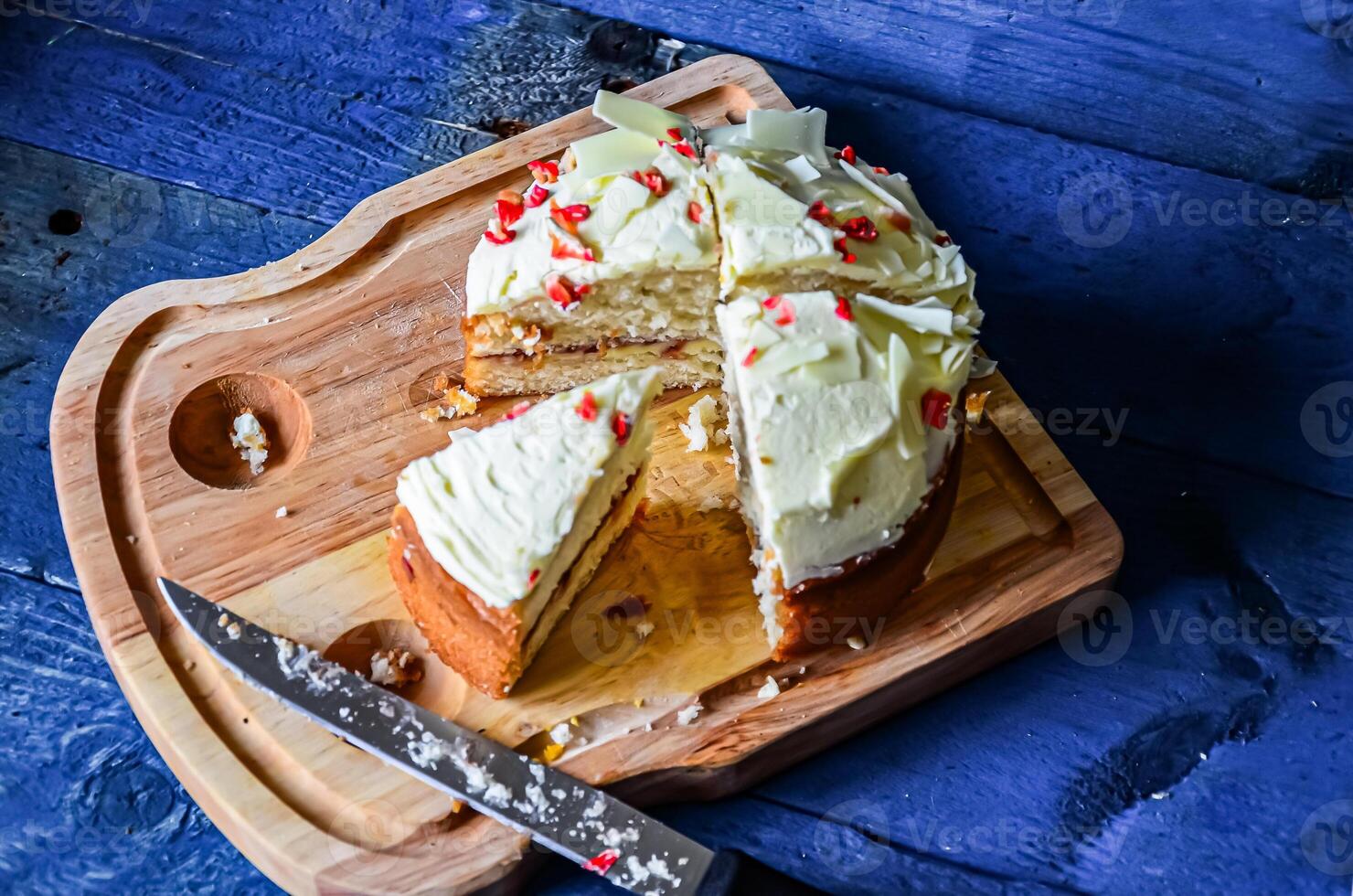 Sponge cake cut into pieces on a kitchen board. photo