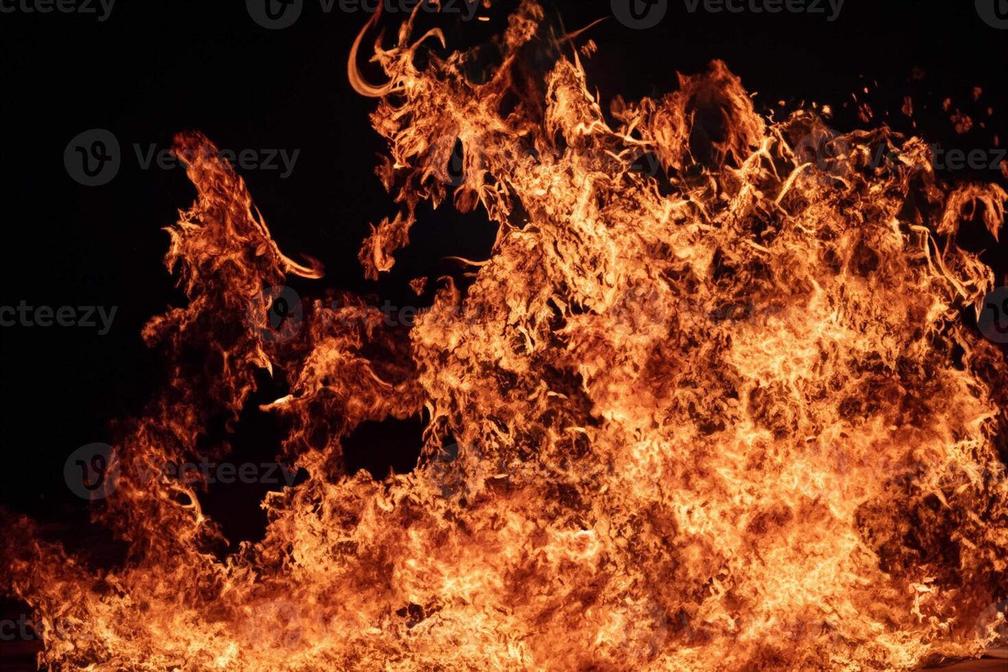 The Mesmerizing Flames Dance Gracefully Against the Pitchblack Backdrop, Creating an Enchanting and Captivating Scene photo