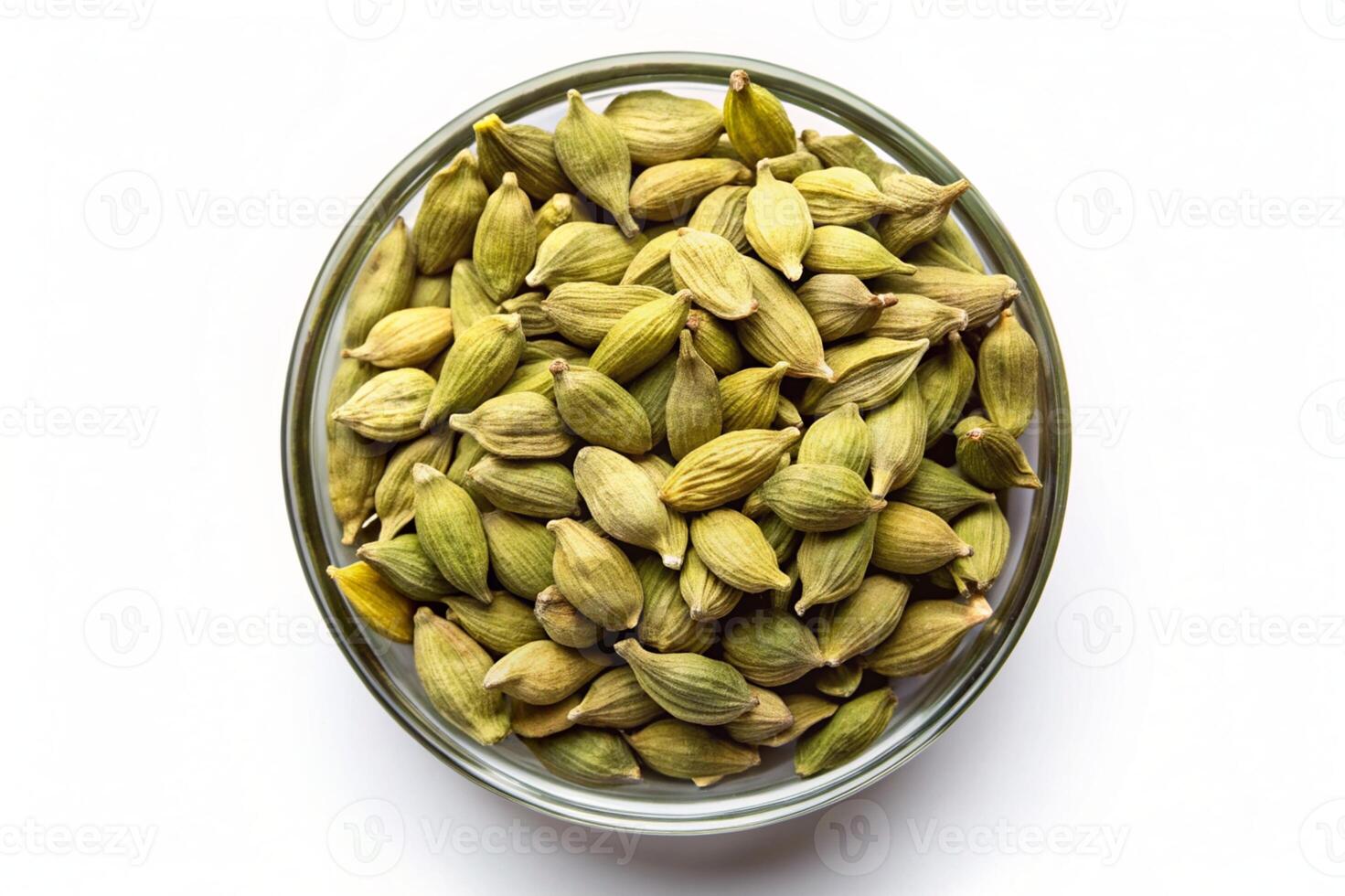 cardamom seeds in a glass bowl on a white background photo