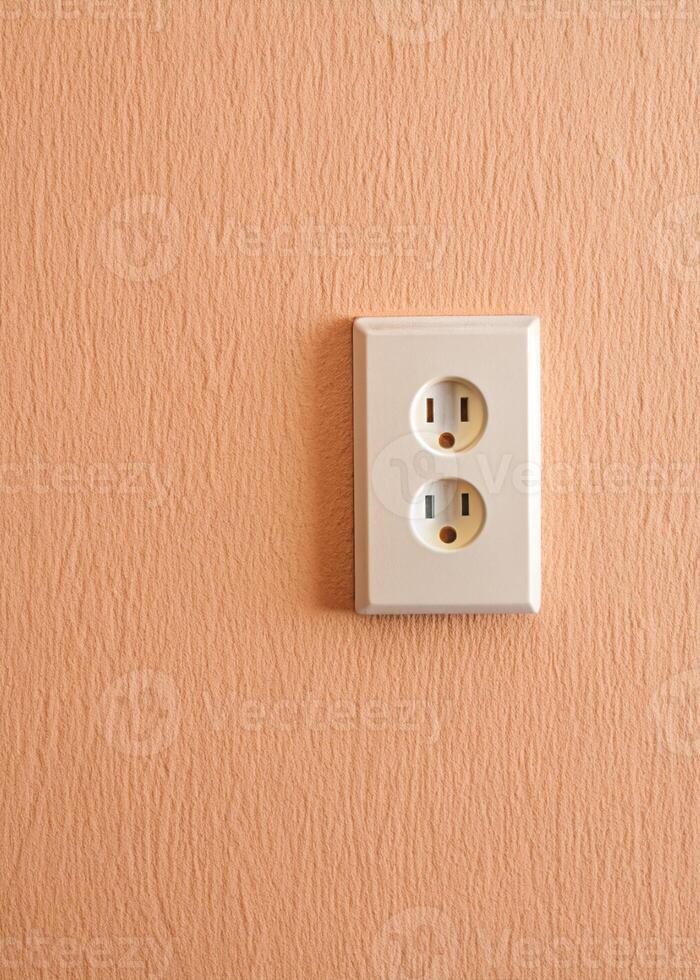 an electrical outlet on a wall with a white plug photo