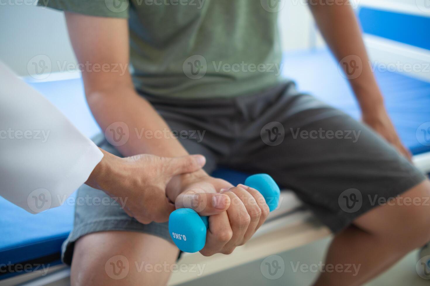 doctor is checking for muscle injuries and using dumbbells test injury and also help with physical therapy strengthen muscles because physical therapy will help strengthen muscles and help blood flow photo