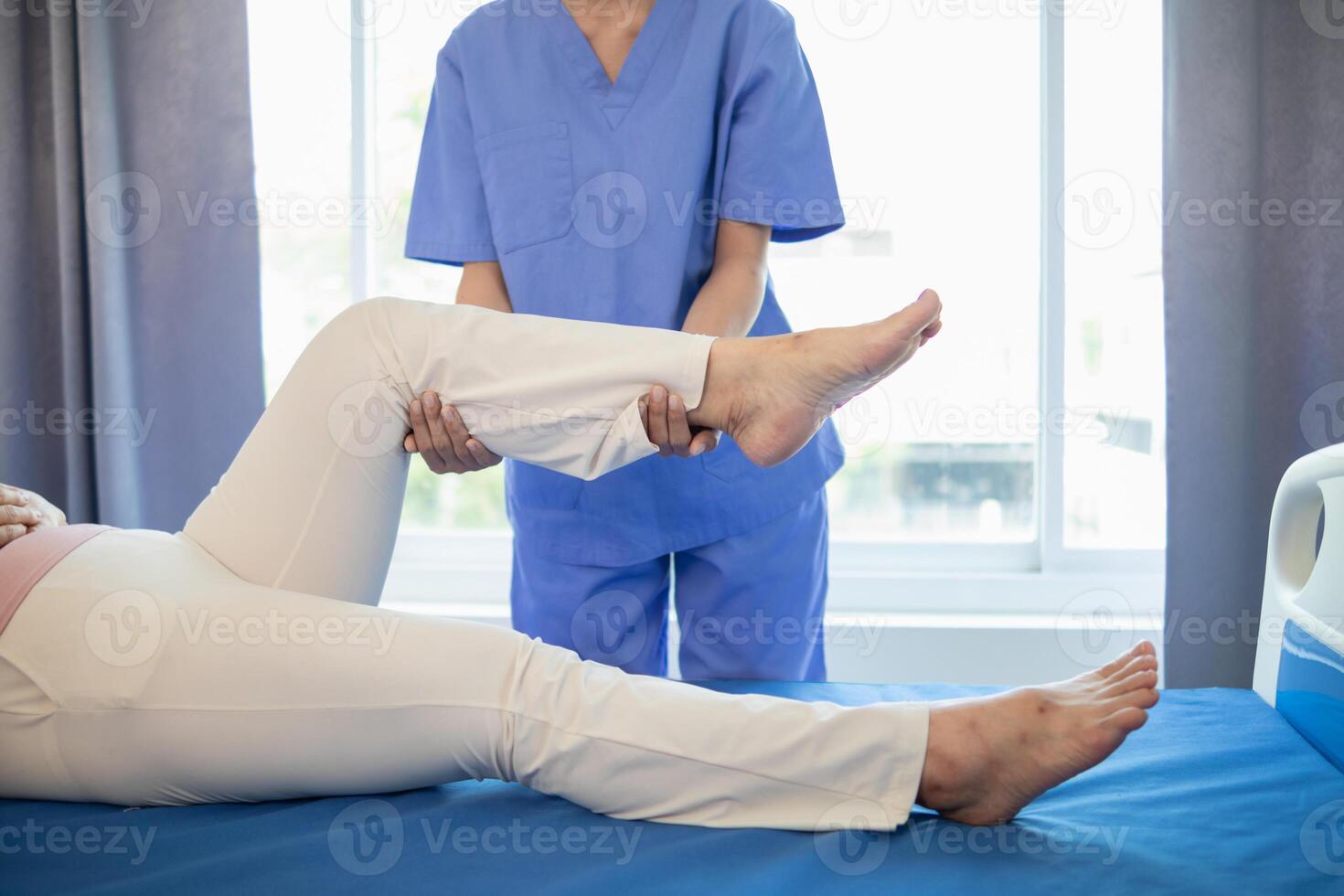 female doctor is helping a patient move her muscles after recuperating from a muscle injury and wanting to rehabilitate her to be able to use her normal daily life with continuous physical therapy. photo