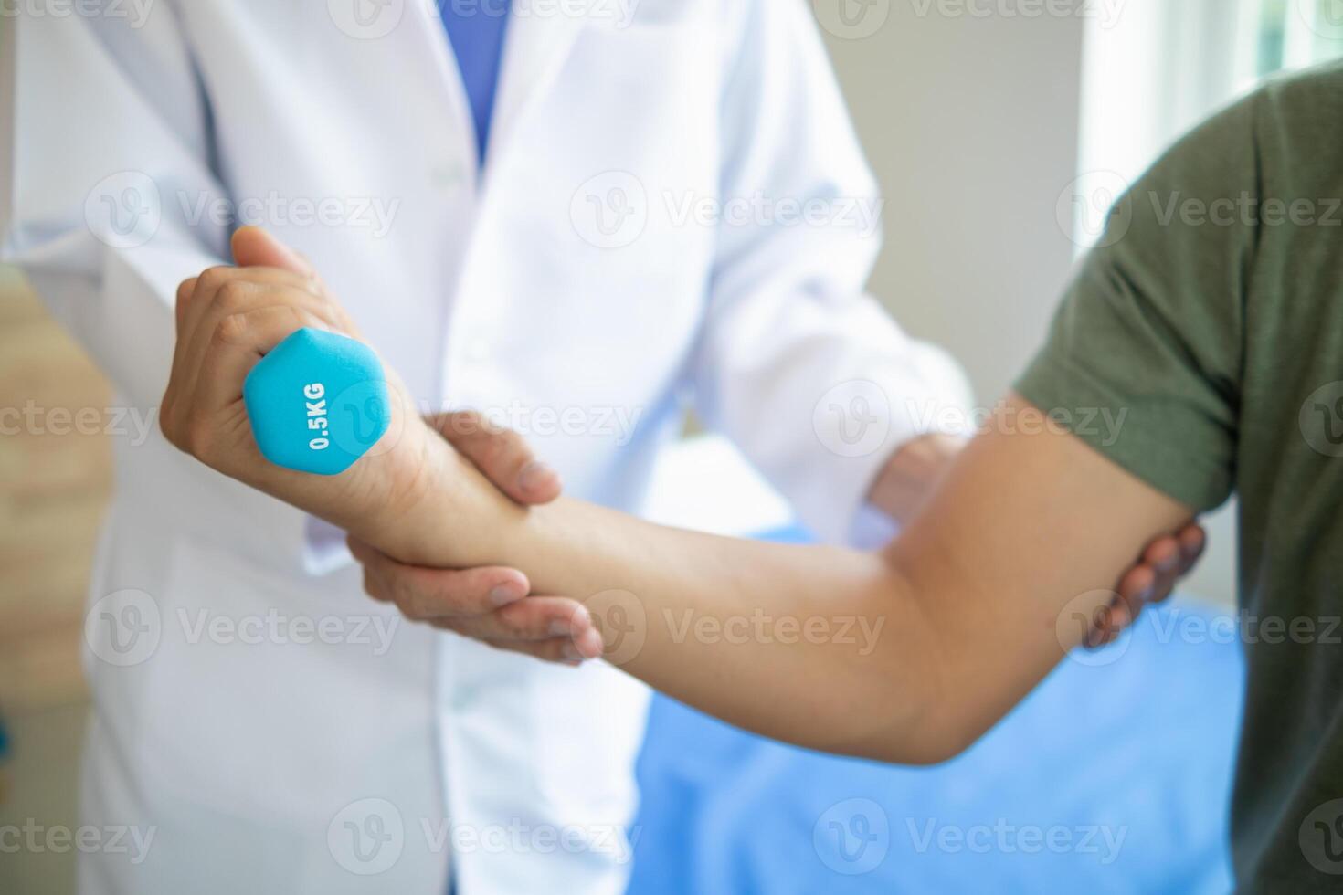doctor is checking for muscle injuries and using dumbbells test injury and also help with physical therapy strengthen muscles because physical therapy will help strengthen muscles and help blood flow photo