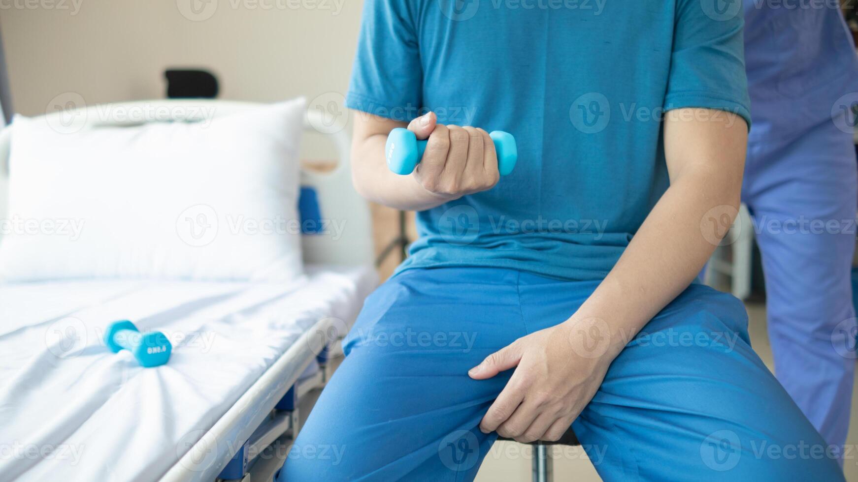 doctor is checking for muscle injuries and using dumbbells test injury and also help with physical therapy strengthen muscles because physical therapy will help strengthen muscles and help blood flow photo