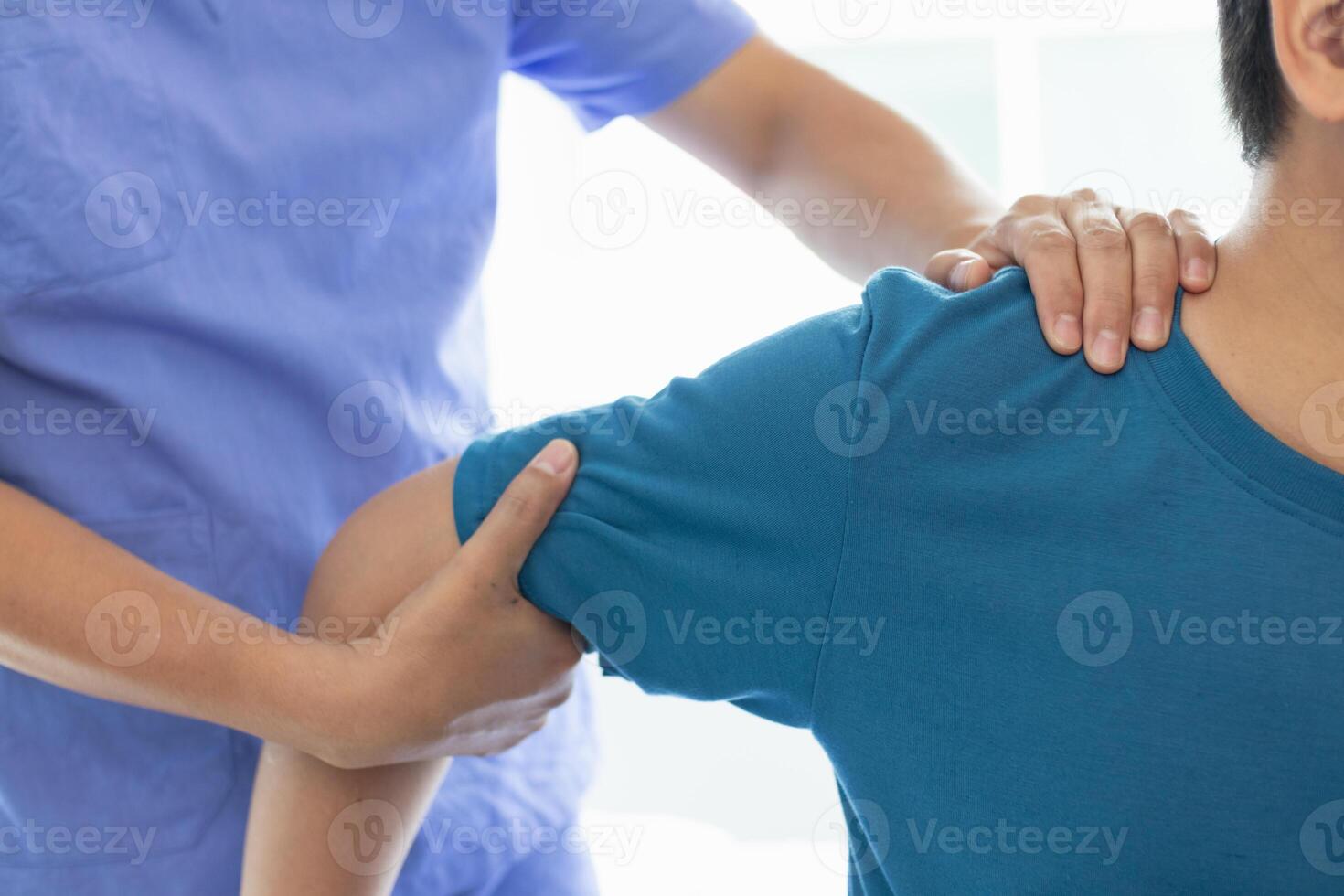 man was admitted for treatment of muscle pain in back of his shoulder due to working hard and causing muscle inflammation. doctor is treating man muscle pain in his back and shoulders due to overwork. photo