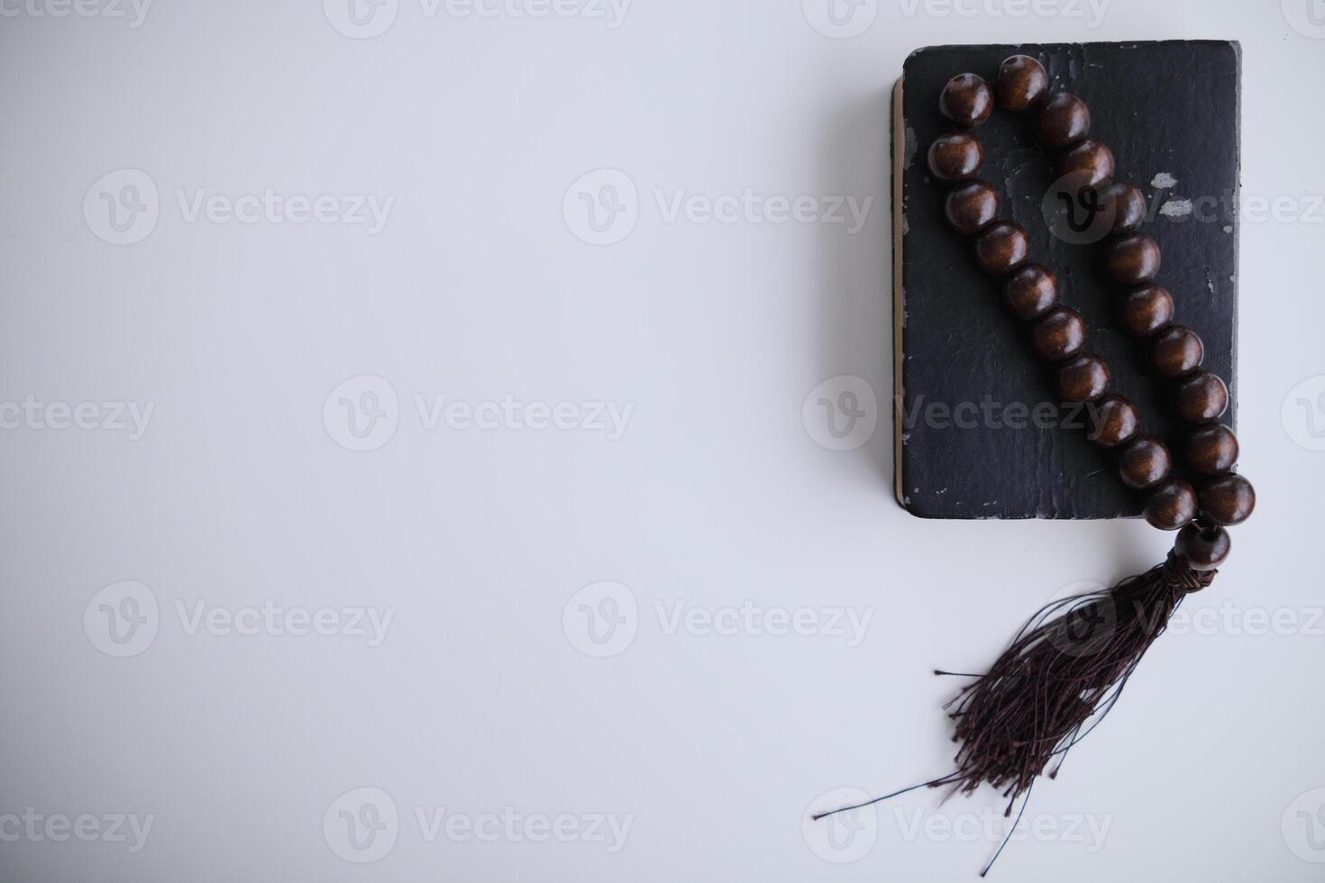 Bible lies on a wooden table after praying to God, which is a Christian religious ritual and belief in the teachings of God. The concept of praying God with the teachings of the Bible and the cross. photo