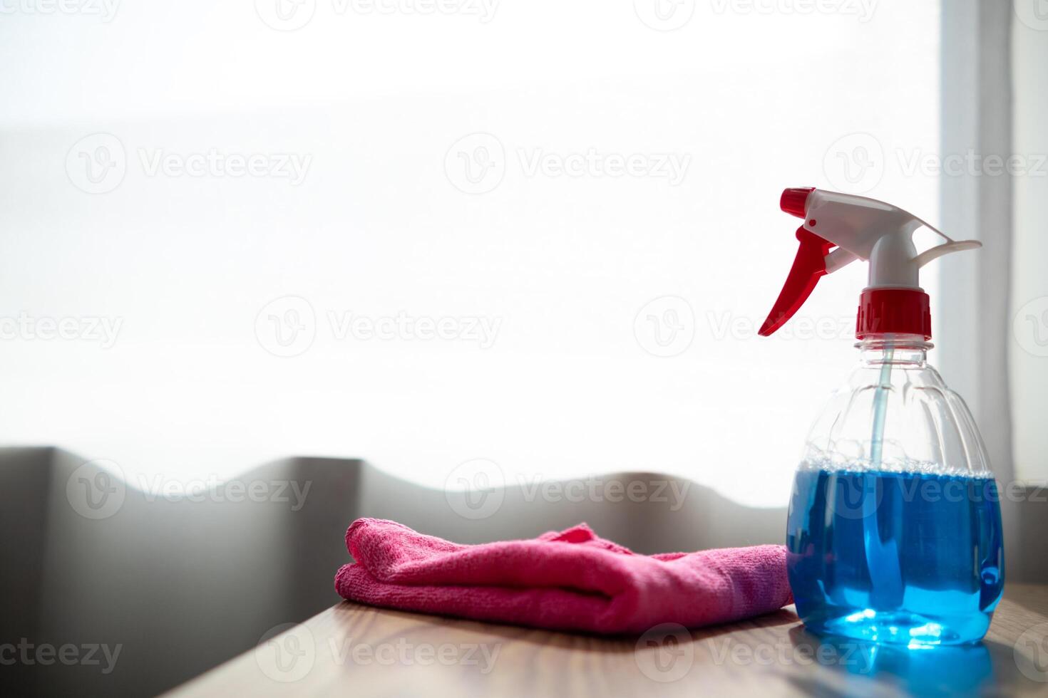 The disinfectant-based cleaning solution is prepared in a spray bottle for easy spraying to clean office interiors and furniture surfaces. Concept of contract Hire a cleaner and spraying disinfectant photo