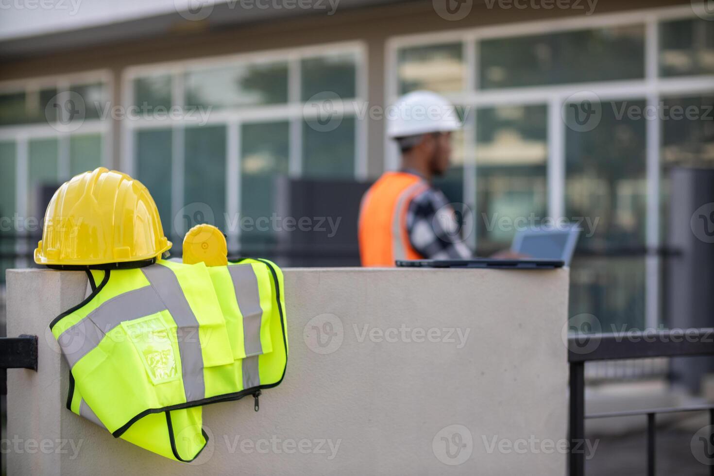 Yellow safety helmet are provided along with reflective vests for workers wear because Yellow safety helmets protect against falling objects during construction and reflective vests provide visibility photo