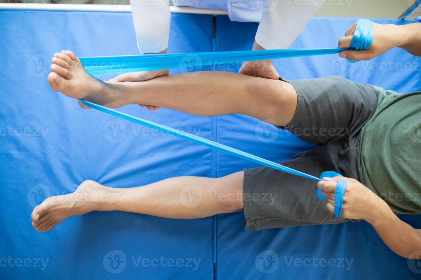 Doctors are examining patient muscle injuries and doing physical therapy for patient to move muscles so they can be used regularly because physical therapy will help strengthen muscles and blood flow. photo