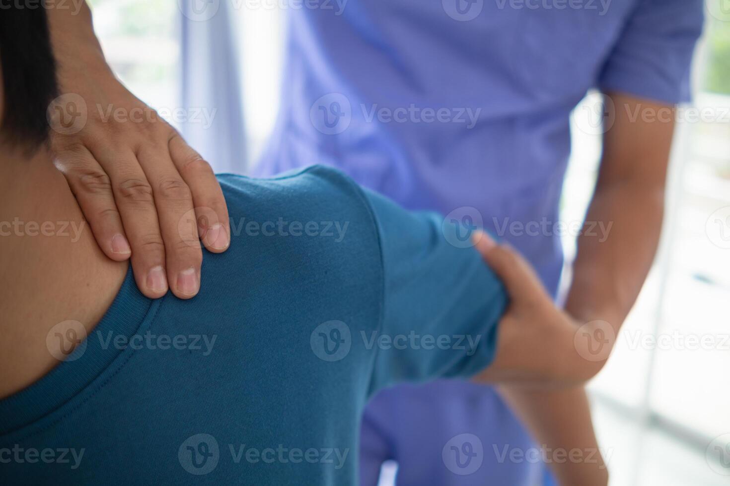 man was admitted for treatment of muscle pain in back of his shoulder due to working hard and causing muscle inflammation. doctor is treating man muscle pain in his back and shoulders due to overwork. photo