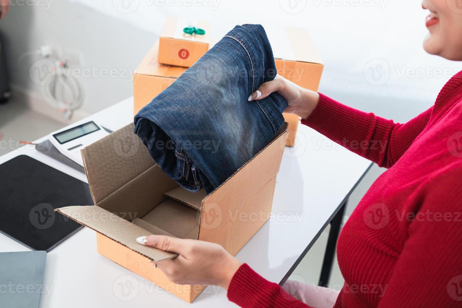SME business operator is inspecting and packing products into parcel box for delivery company that will come pick up products after participating in online marketing with Application shopping online photo
