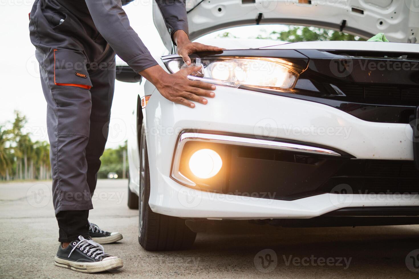 Technicians from service center inspect and assist customers cars that are having problems while traveling build confidence in customers who choose buy car from service center and receive help quickly photo