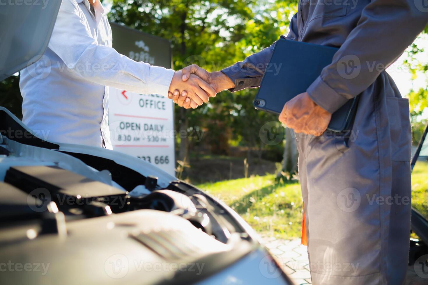 Technicians from service center inspect and assist customers cars that are having problems while traveling build confidence in customers who choose buy car from service center and receive help quickly photo