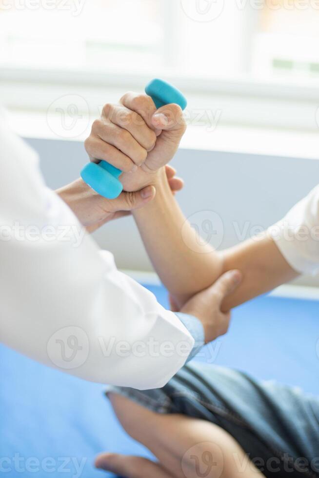 doctor is checking for muscle injuries and using dumbbells test injury and also help with physical therapy strengthen muscles because physical therapy will help strengthen muscles and help blood flow photo