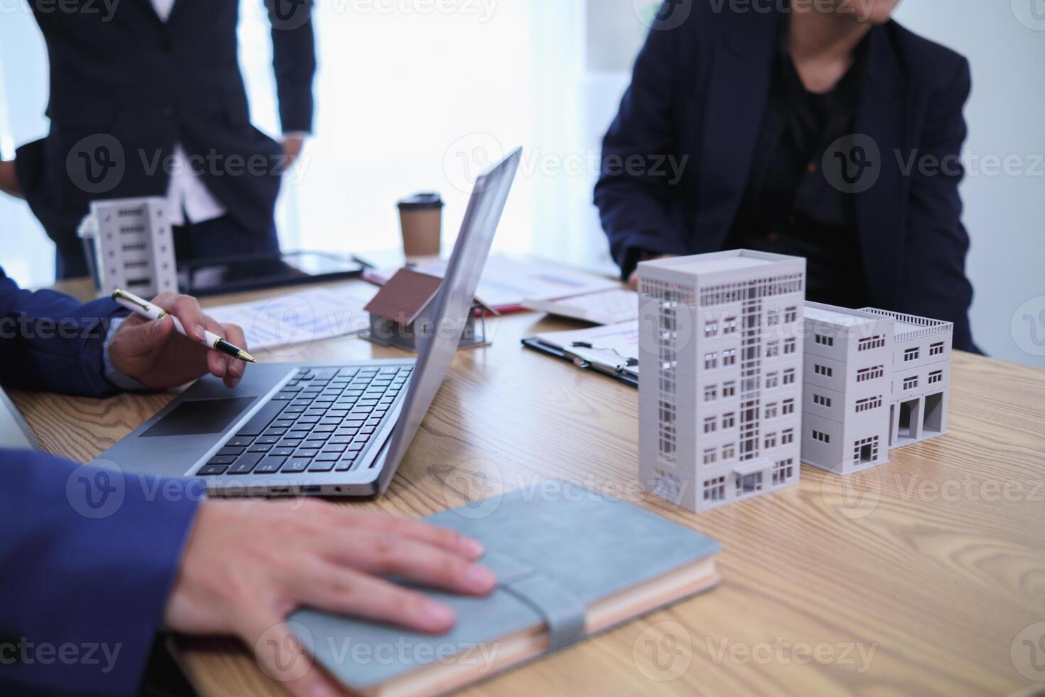 group of businessmen and investors discuss investing in real estate and jointly plan investments in construction projects of condominiums and apartments for sale and rent. investment advisory concept photo