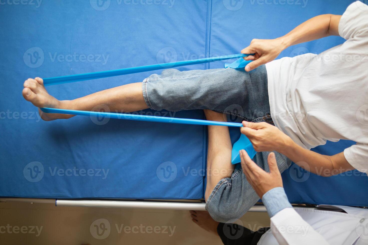 Doctors are examining patient muscle injuries and doing physical therapy for patient to move muscles so they can be used regularly because physical therapy will help strengthen muscles and blood flow. photo