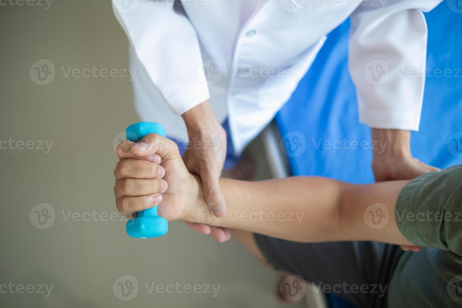 doctor is checking for muscle injuries and using dumbbells test injury and also help with physical therapy strengthen muscles because physical therapy will help strengthen muscles and help blood flow photo
