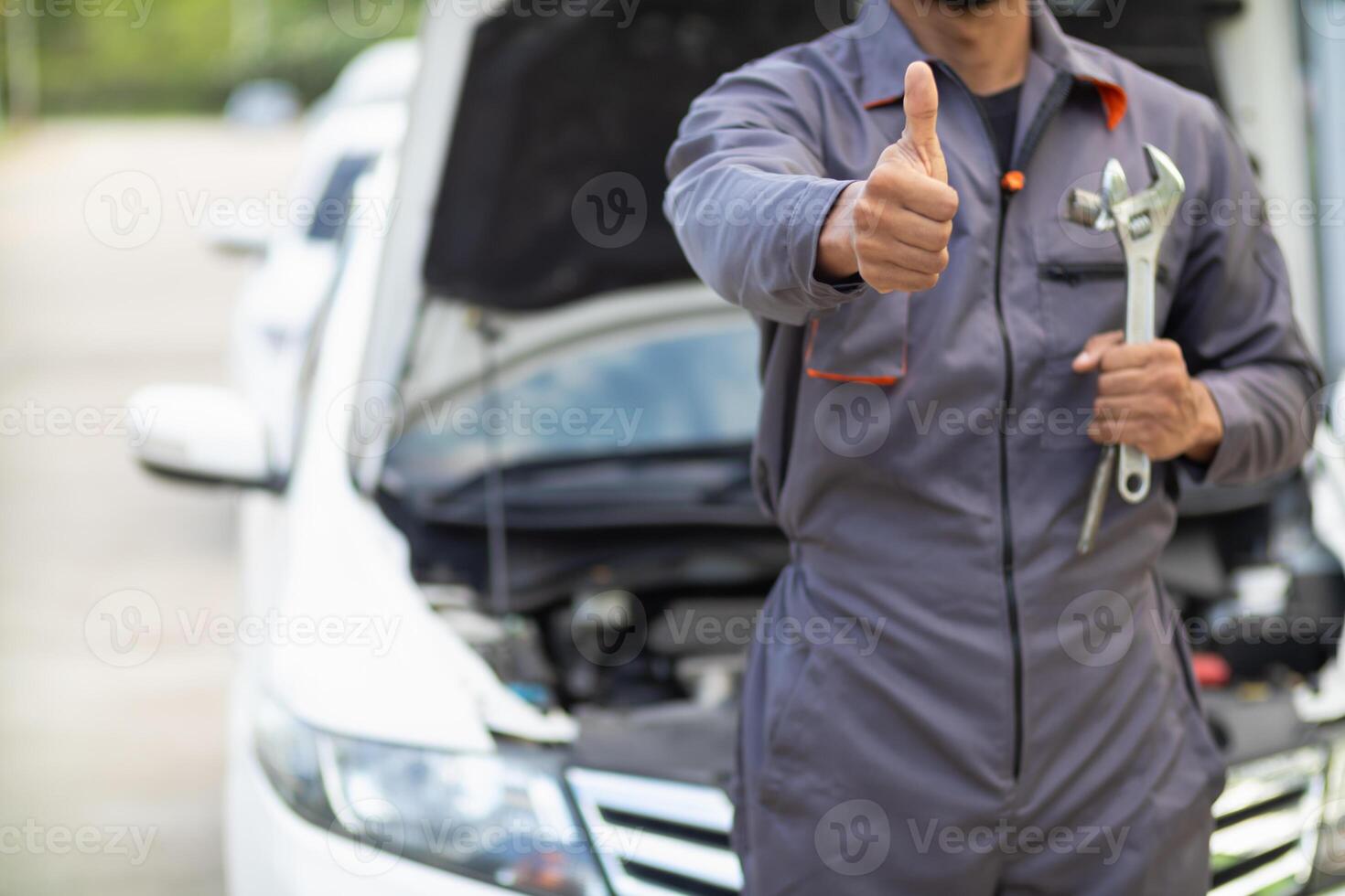 Technicians from service center inspect and assist customers cars that are having problems while traveling build confidence in customers who choose buy car from service center and receive help quickly photo