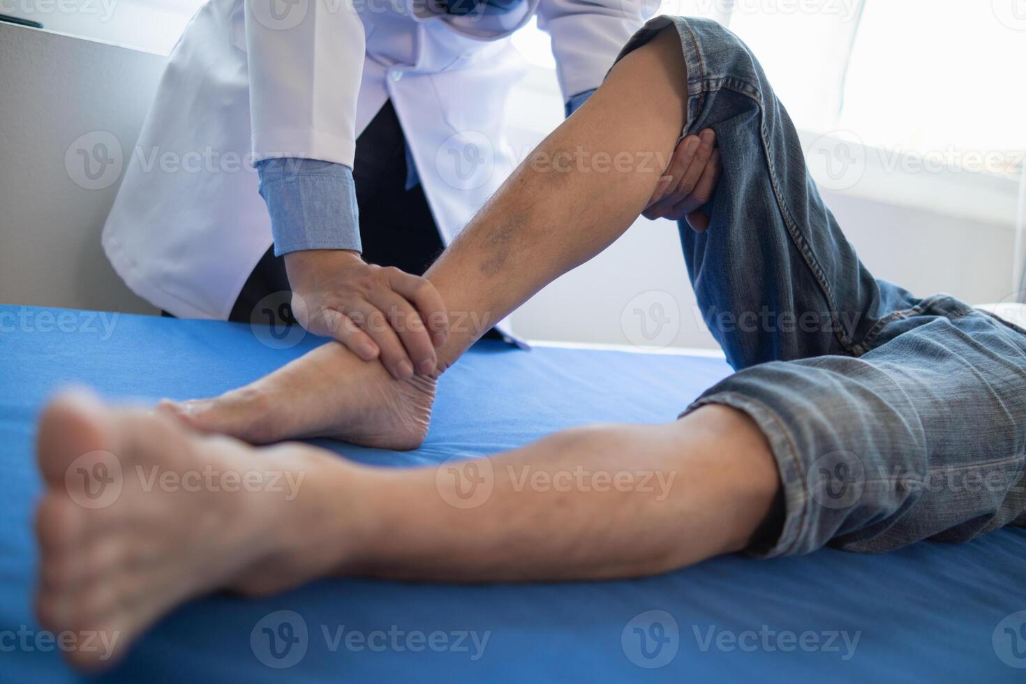 Doctors are examining patient muscle injuries and doing physical therapy for patient to move muscles so they can be used regularly because physical therapy will help strengthen muscles and blood flow. photo