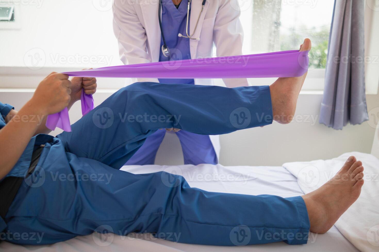 Doctors are examining patient muscle injuries and doing physical therapy for patient to move muscles so they can be used regularly because physical therapy will help strengthen muscles and blood flow. photo