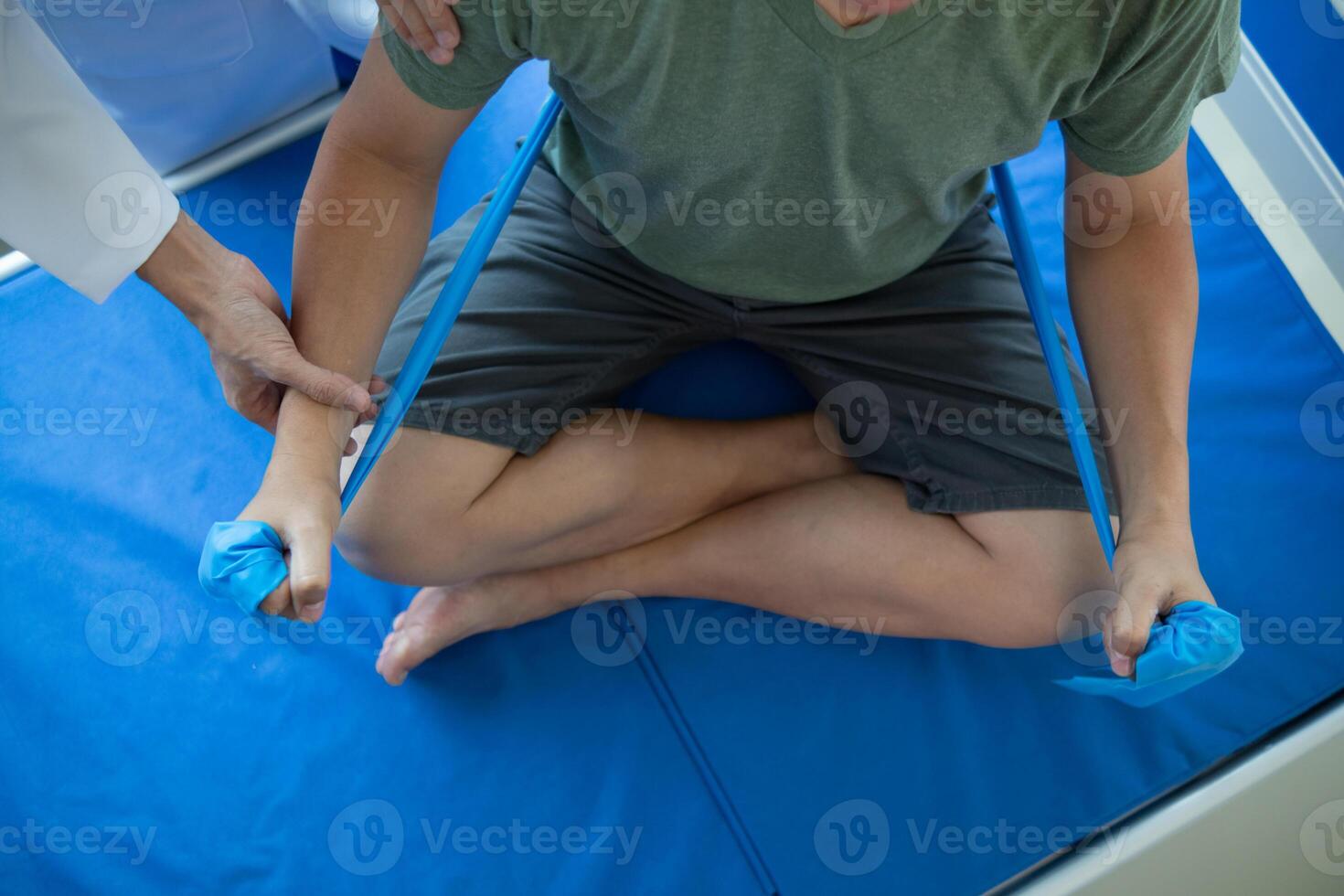 doctor is examining muscle injury and using elastic bands test injury and also help with physical therapy strengthen muscles because physical therapy will help strengthen muscles and help blood flow. photo