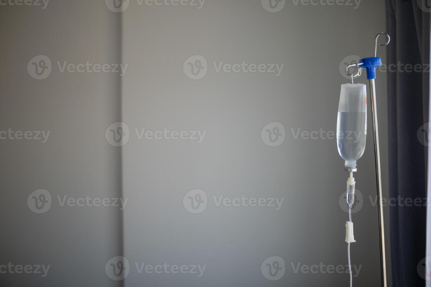 Bottles saline are hung on poles for giving saline patients and passing them through an intravenous line on patient bed. Medical which doctor gives saline solution patient through an intravenous photo