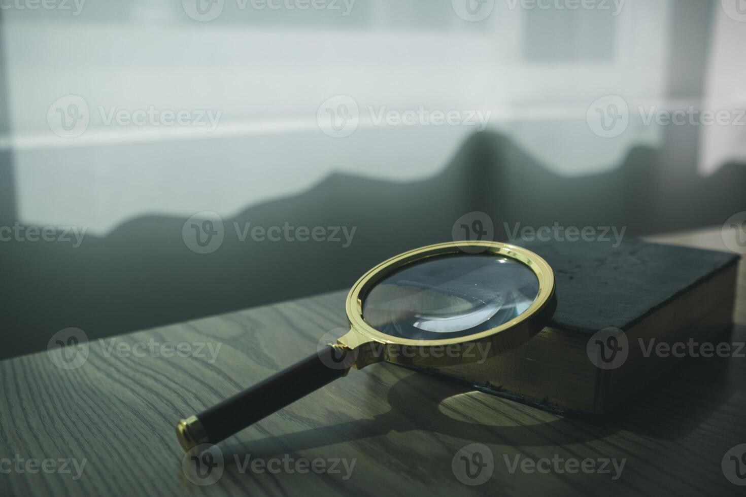 A Bible and a magnifying glass are placed on a wooden table after praying to God Christian religious ritual and belief in the teachings of God. Ideas for praying to God with teachings from the Bible photo