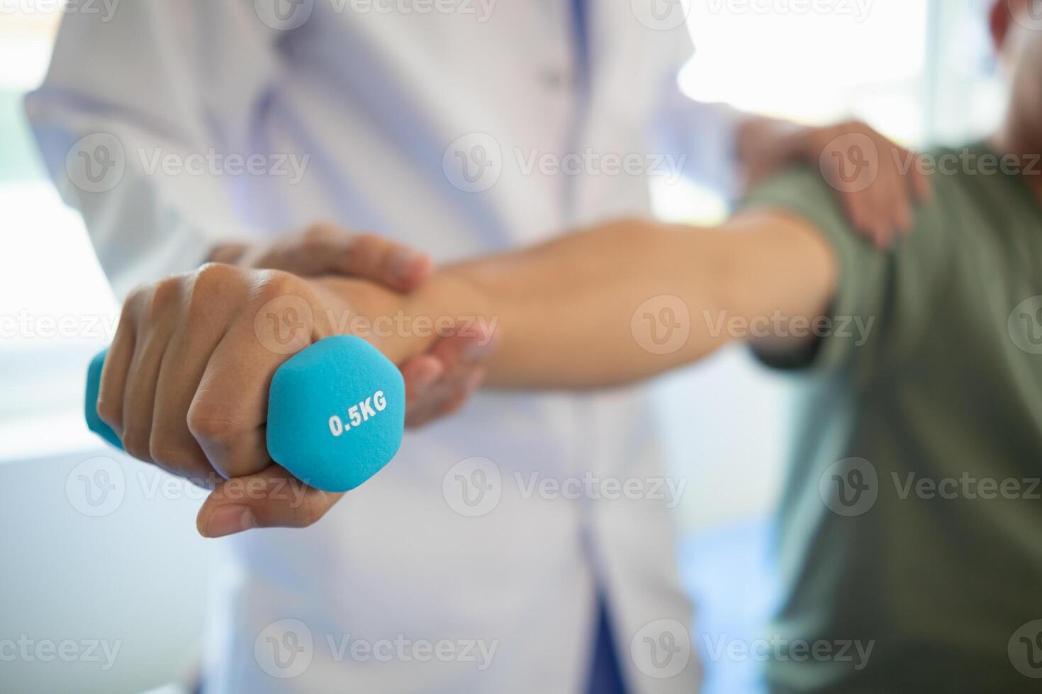 doctor is checking for muscle injuries and using dumbbells test injury and also help with physical therapy strengthen muscles because physical therapy will help strengthen muscles and help blood flow photo