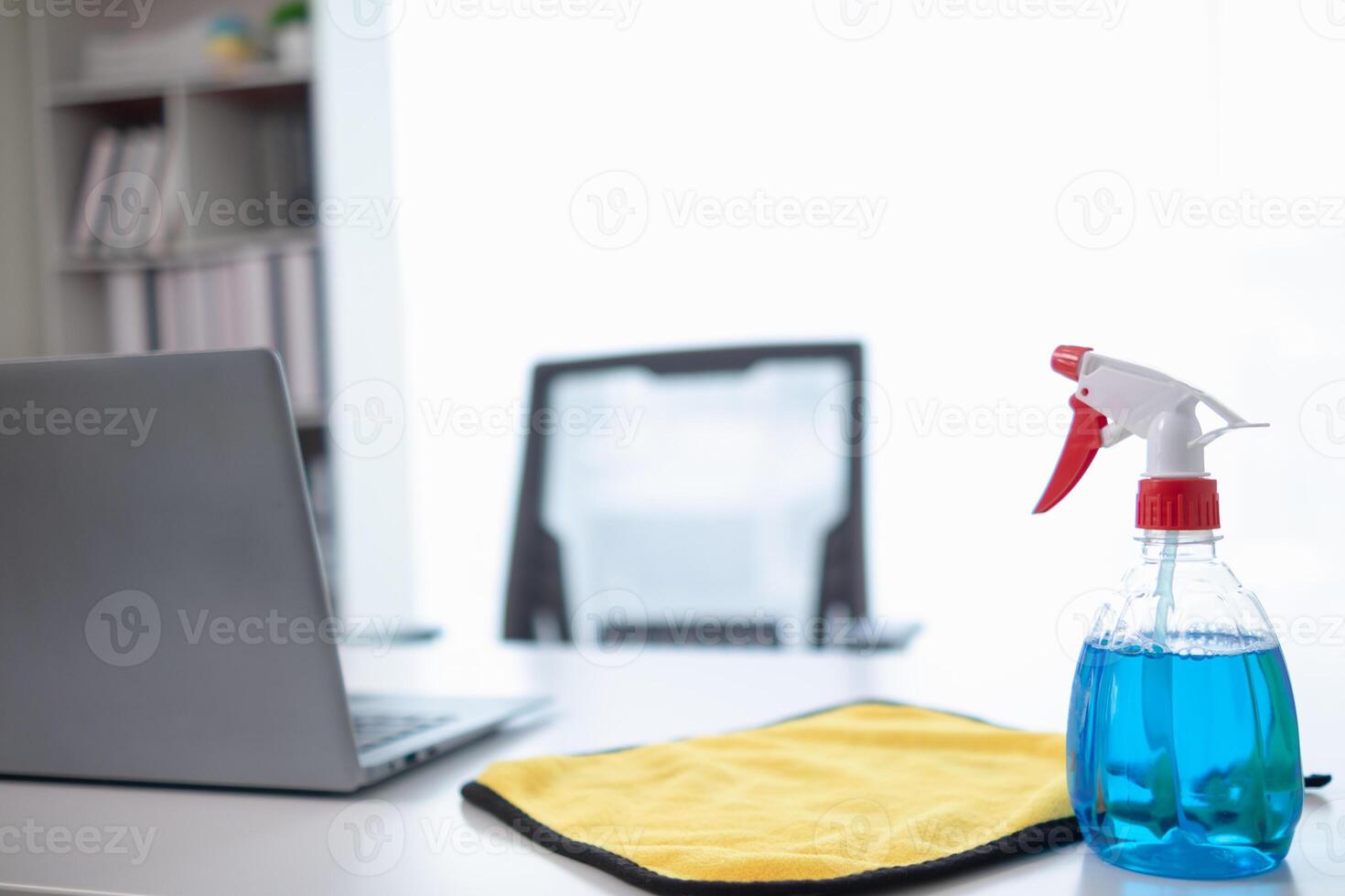The disinfectant-based cleaning solution is prepared in a spray bottle for easy spraying to clean office interiors and furniture surfaces. Concept of contract Hire a cleaner and spraying disinfectant photo