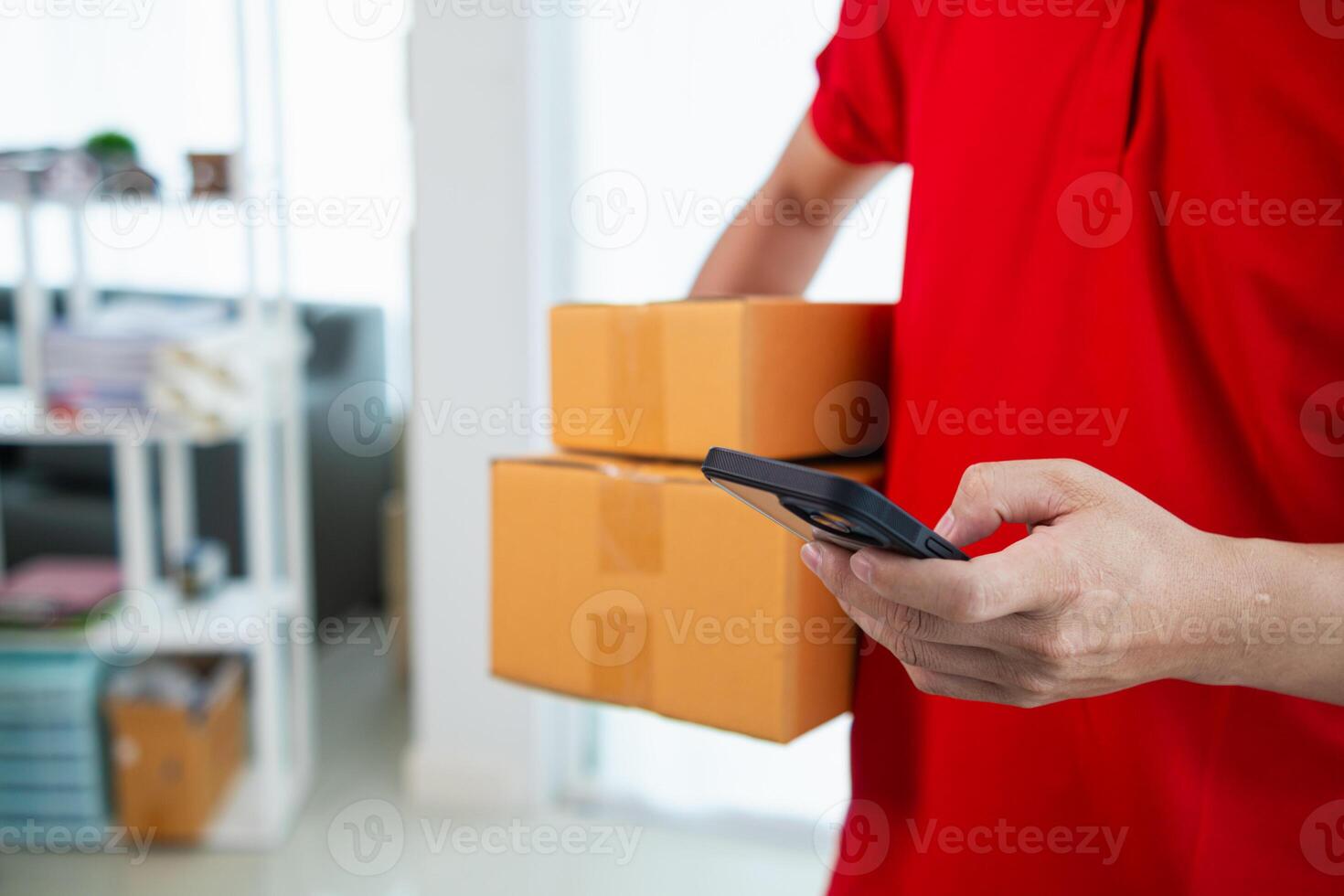 SME business operator is inspecting and packing products into parcel box for delivery company that will come pick up products after participating in online marketing with Application shopping online photo