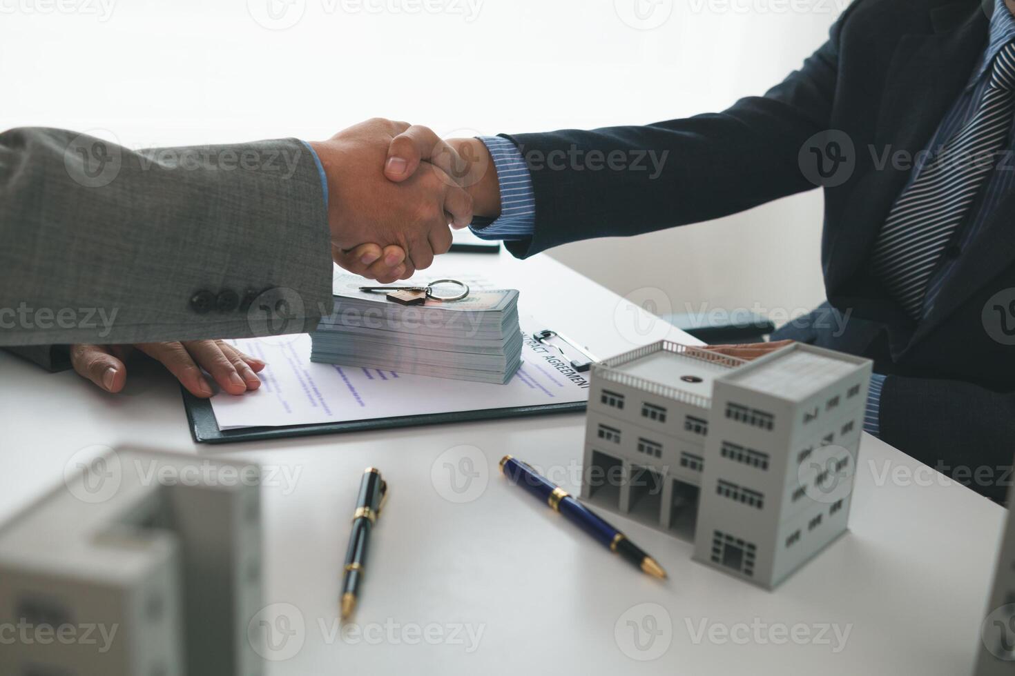 Real estate brokers offer attractive promotions customers so they can decide purchase condominium unit for living and as value added asset. Concept of signing real estate purchase contract with dealer photo