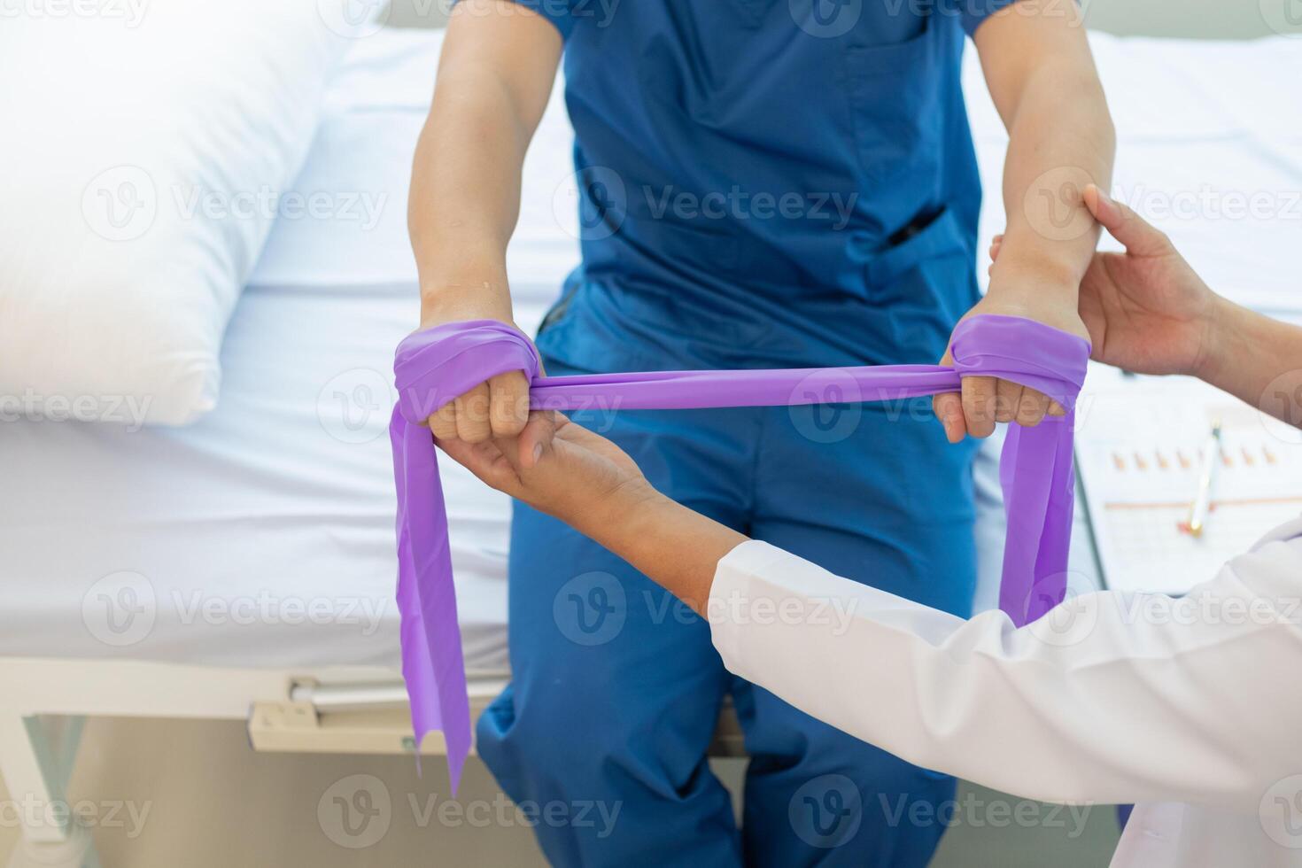 doctor is examining muscle injury and using elastic bands test injury and also help with physical therapy strengthen muscles because physical therapy will help strengthen muscles and help blood flow. photo