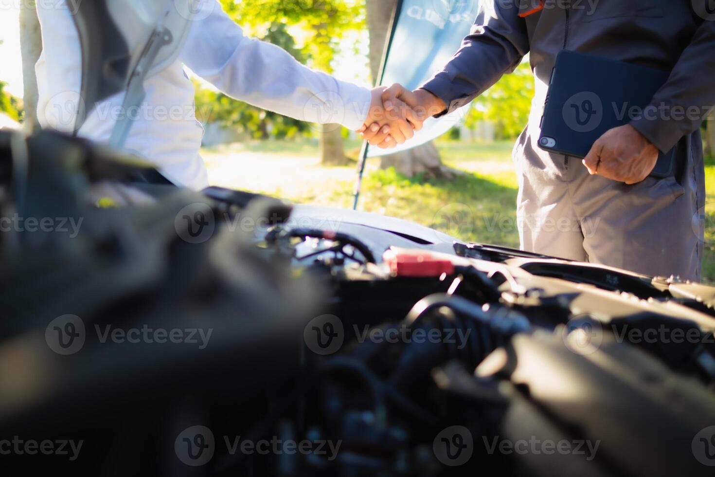 Technicians from service center inspect and assist customers cars that are having problems while traveling build confidence in customers who choose buy car from service center and receive help quickly photo