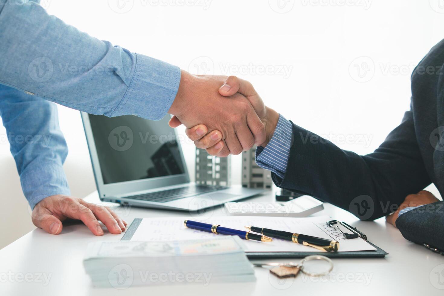 Real estate brokers offer attractive promotions customers so they can decide purchase condominium unit for living and as value added asset. Concept of signing real estate purchase contract with dealer photo
