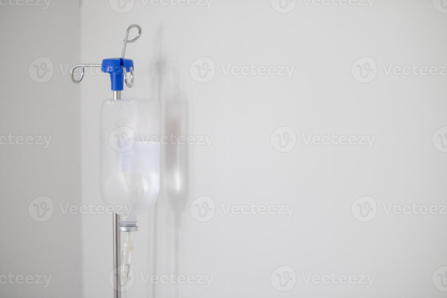 Bottles saline are hung on poles for giving saline patients and passing them through an intravenous line on patient bed. Medical which doctor gives saline solution patient through an intravenous photo
