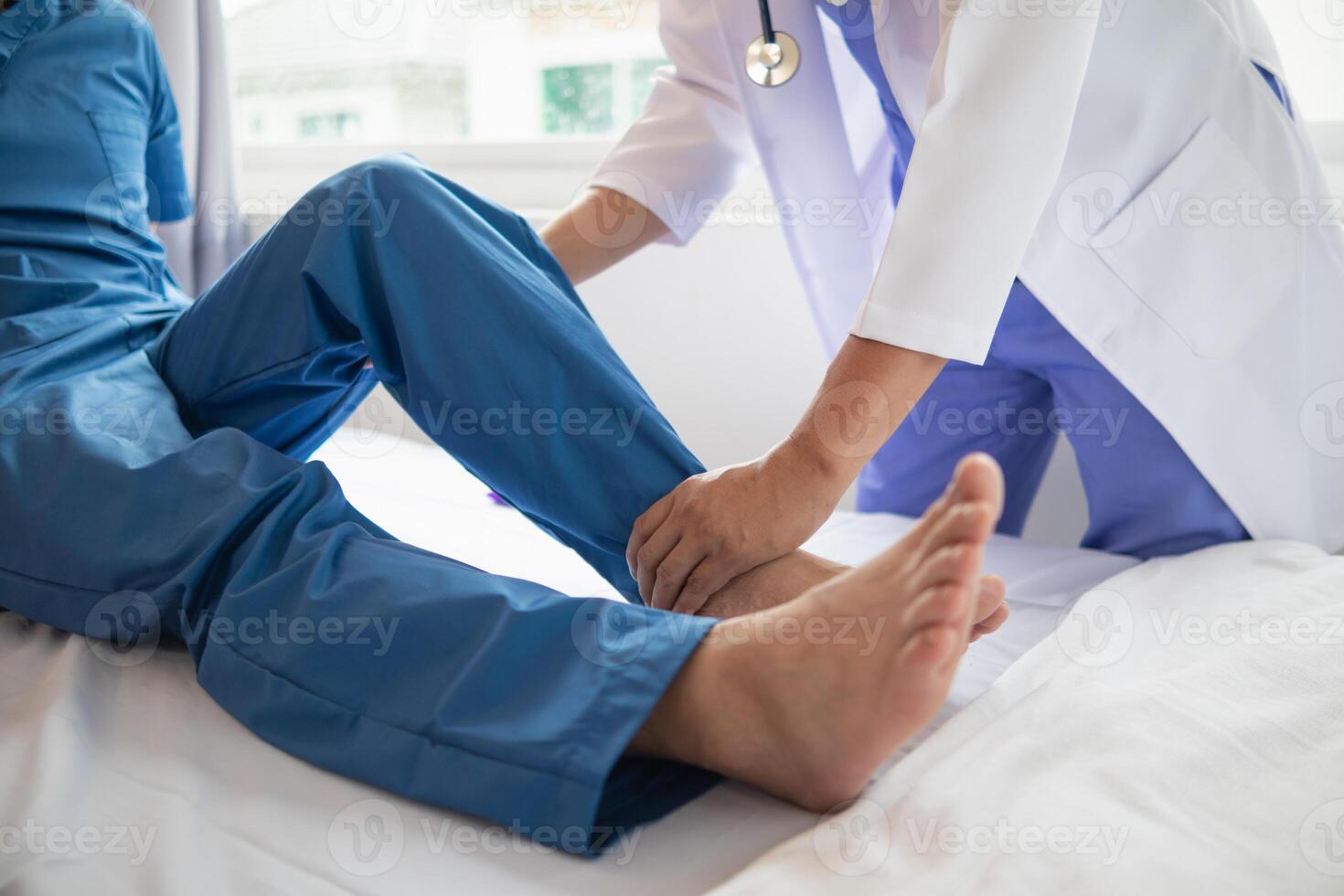 Doctors are examining patient muscle injuries and doing physical therapy for patient to move muscles so they can be used regularly because physical therapy will help strengthen muscles and blood flow. photo