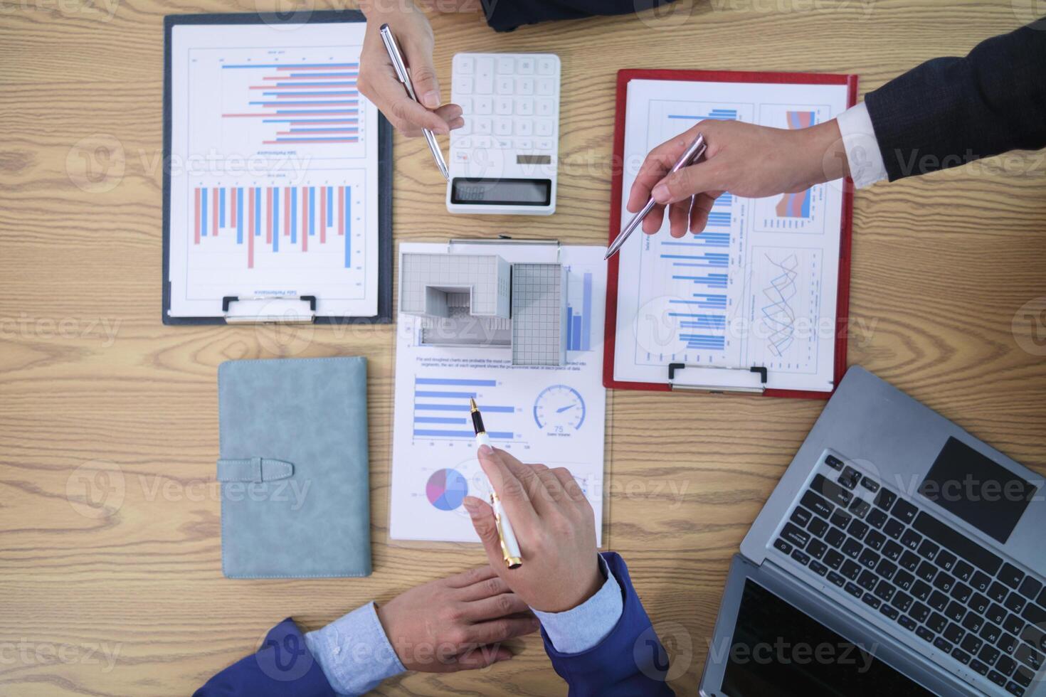 group of businessmen and investors discuss investing in real estate and jointly plan investments in construction projects of condominiums and apartments for sale and rent. Top View photo