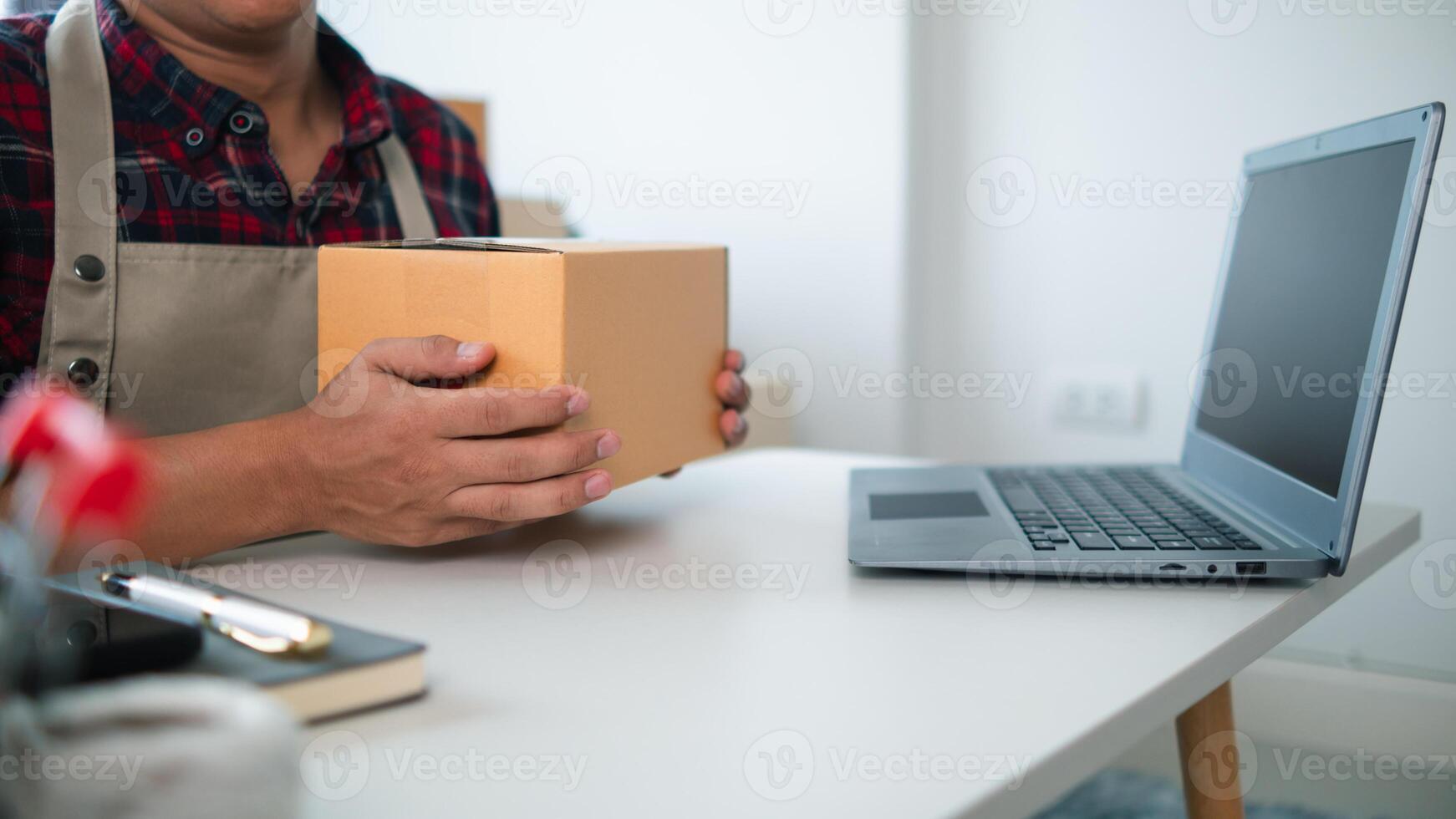 SME business operator is inspecting and packing products into parcel box for delivery company that will come pick up products after participating in online marketing with Application shopping online photo