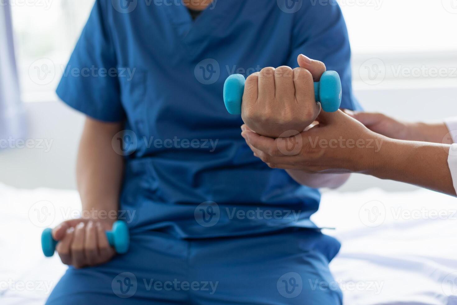 doctor is helping a patient move her muscles after recuperating from a muscle injury and wanting to rehabilitate her to be able to use her normal daily life with continuous physical therapy. photo