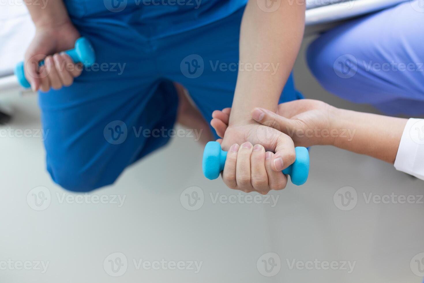doctor is checking for muscle injuries and using dumbbells test injury and also help with physical therapy strengthen muscles because physical therapy will help strengthen muscles and help blood flow photo